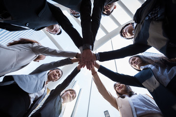 business people group joining hands and representing concept of friendship and teamwork