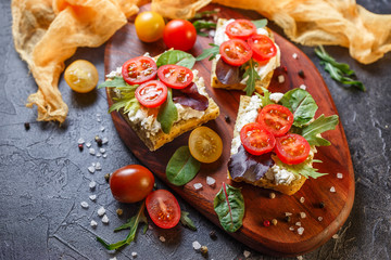 Two fresh sandwiches with cherry tomatoes