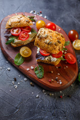Two fresh sandwiches with cherry tomatoes