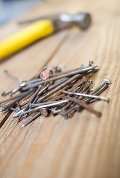 Close up image of screws and nails on a wooden surface ready for use in a DIY project