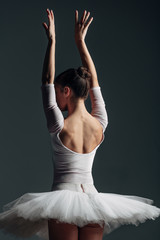 Young beautiful ballerina posing in studio