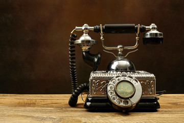 Vintage telephone on wooden table.