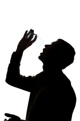 Young man drinks soda water, no water - silhouette