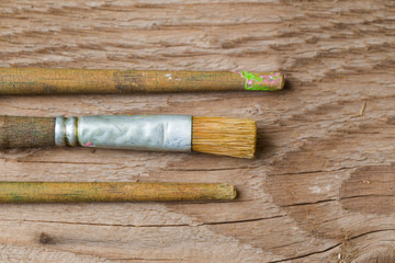 Close up view of various Paint brushes on a wooden surface ready for use in DIY paint project