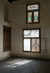 Fototapeta premium Old abandoned dark damaged dirty room with two wooden broken ornate windows