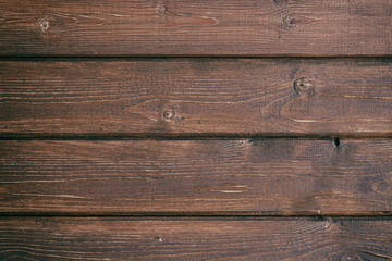 Retro background from wooden boards painted in dark brown color