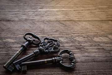   Vintage key on a wooden chocolate background with solar Blick