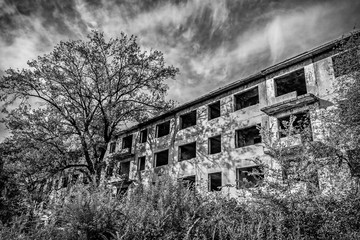 ruined house in a poor residential quarter in a slum. Noise and grain are added deliberately by a...