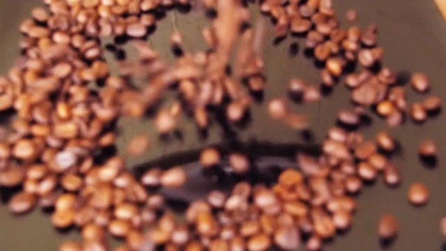 Coffee beans. Close-up. Along coffee beans. Floating over fried coffee. Slow-motion