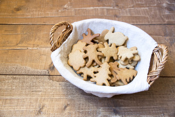 Ginger biscuits in basket on wooden boards