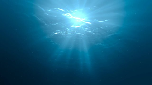 Sunlight rays shining through ocean surface. View from underwater. 3D rendered seamless loop animation.