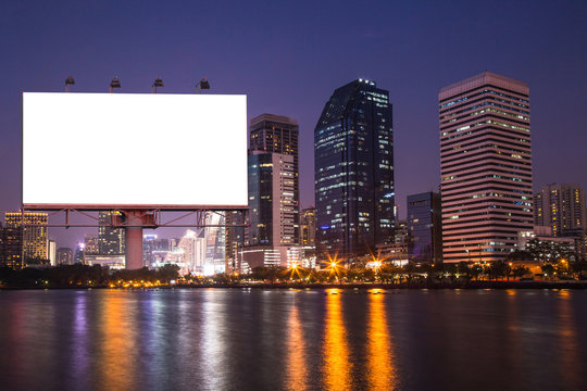 lake in the night city with white blank billboard