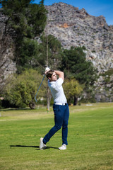 Young golfer getting ready on a golf course to play a round of golf