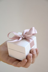 a gift in a white box with a pink bow