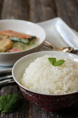 Thai jasmine rice served with Shrimp green curry sauce, selective focus