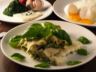 Cannelloni con ricotta e spinaci. Italian pasta with ricotta and spinach, basil, blue cheese, egg, flour, onion and garlic. Delicious food.