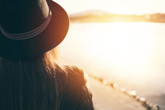 Rear View Of Hipster Woman With Hat At Sunset