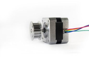Electric stepper motor with a shiny metal timing pulley mounted to the shaft is laying down on its...