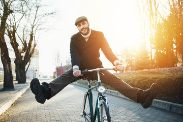 Man with bicycle having fun - obrazy, fototapety, plakaty