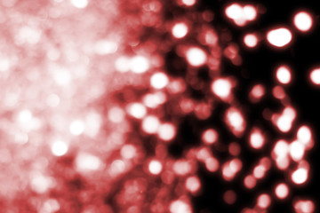 Red  abstract festive background, glitter or bokeh lights. Round defocused particles.