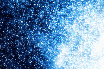 Abstract blue round  bokeh or glitter lights isolated on black background. Circles and defocused particles