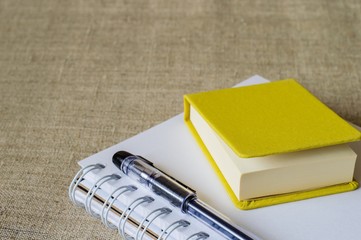 Yellow mini-notepad, notepad for sketches and black pen.