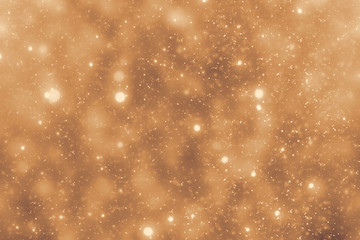 Golden rays and sparkles or glitter lights. Merry Christmas festive gold background.defocused...