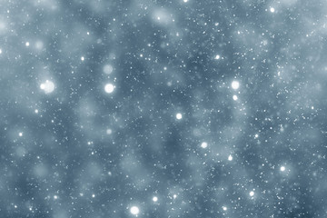 Snowflakes particles and bokeh or glitter lights on silver background. Christmas abstract template