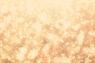 Golden rays and sparkles or glitter lights. Merry Christmas festive gold background.defocused circle bokeh or particles