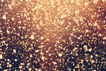 Golden rays and sparkles or glitter lights. Merry Christmas festive background.defocused circle bokeh or particles