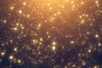 Golden rays and sparkles or glitter lights. Merry Christmas festive background.defocused circle...