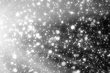 Snowflakes,sun rays  bokeh or glitter lights festive silver  background. Christmas abstract template