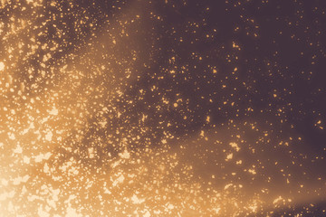 Golden rays and sparkles or glitter lights. Merry Christmas festive background.defocused circle bokeh or particles