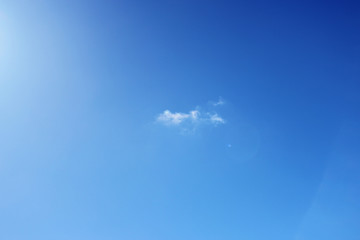 Little lonely cloud in the background of a blue spring sky.