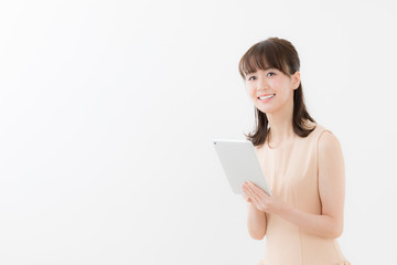 portrait of attractive asian woman using tablet isolated on white background
