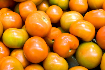 Box of tomatoes on the counter in the supermarket.