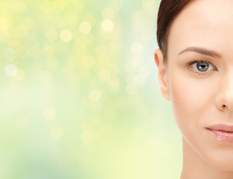 beautiful young woman half face over green