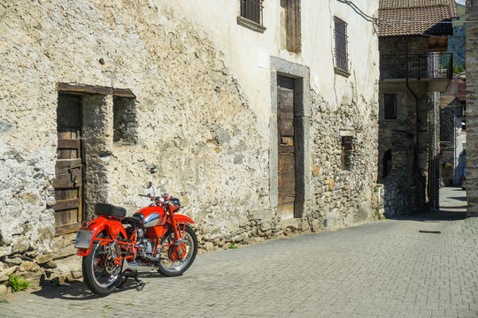 Red bike parked on the street of old town in Italy © elinque
