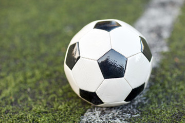 Fototapeta na wymiar soccer ball on football field marking line