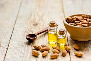 organic cosmetic with almond extract on table background
