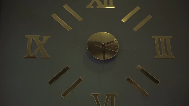 Clock on the wall the design solution in gold color
