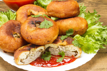 Fried patty on a plate with greens and ketchup