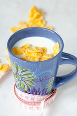 weight loss concept, drink milk with cornflakes and centimeter