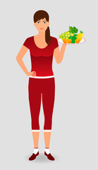 Fototapeta na wymiar Healthy sportswoman holding a fruit tray. Healthy diet concept.