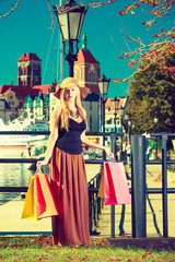 Fashionable woman walking with shopping bags