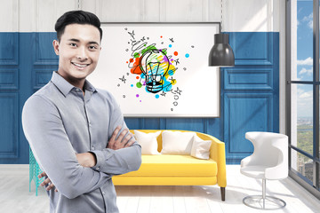 Asian man in office and light bulb