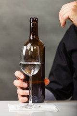 Cup and bottle on table.