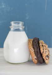 Vertical Varied Cookies Leaning Against Milk Bottle