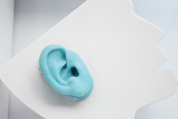 Plastic ear on neutral background