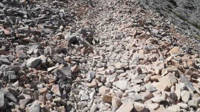 Walking on a rocky path. Slow motion clip.